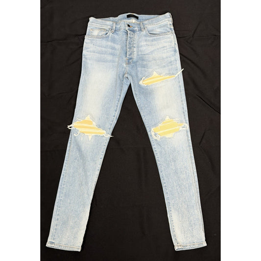 Amiri Men's MX1 Skinny Jeans in a Light Wash Blue and Yellow Patches
