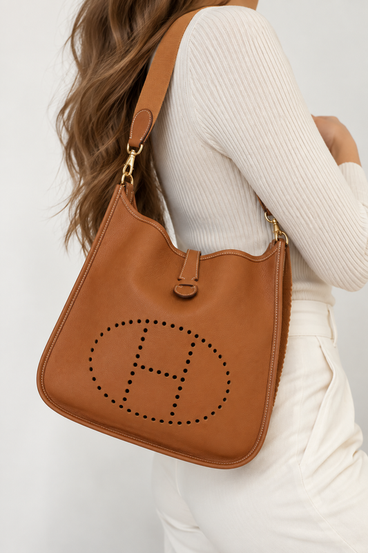 Hermes Evelyne Gold leather shoulder bag worn on model