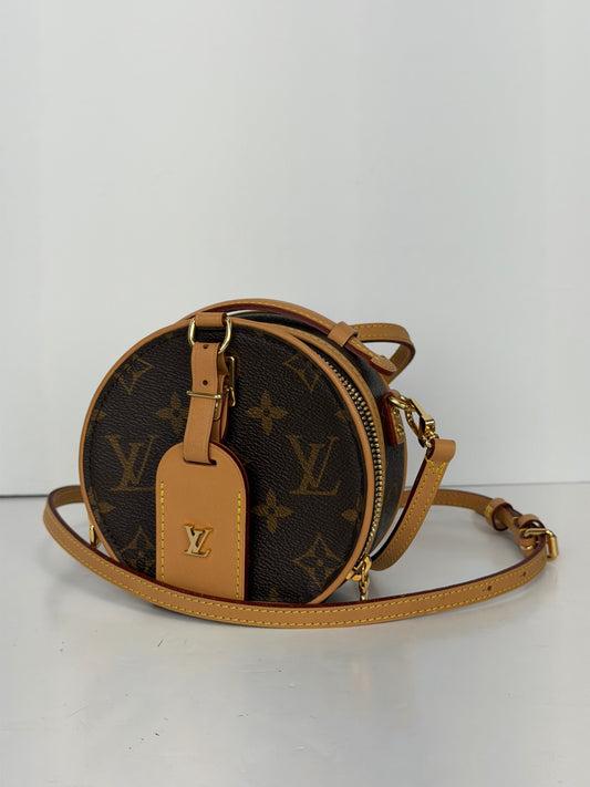 Louis Vuitton Monogram canvas round Petite Boite Chapeau crossbody bag with natural leather trim and gold-tone hardware